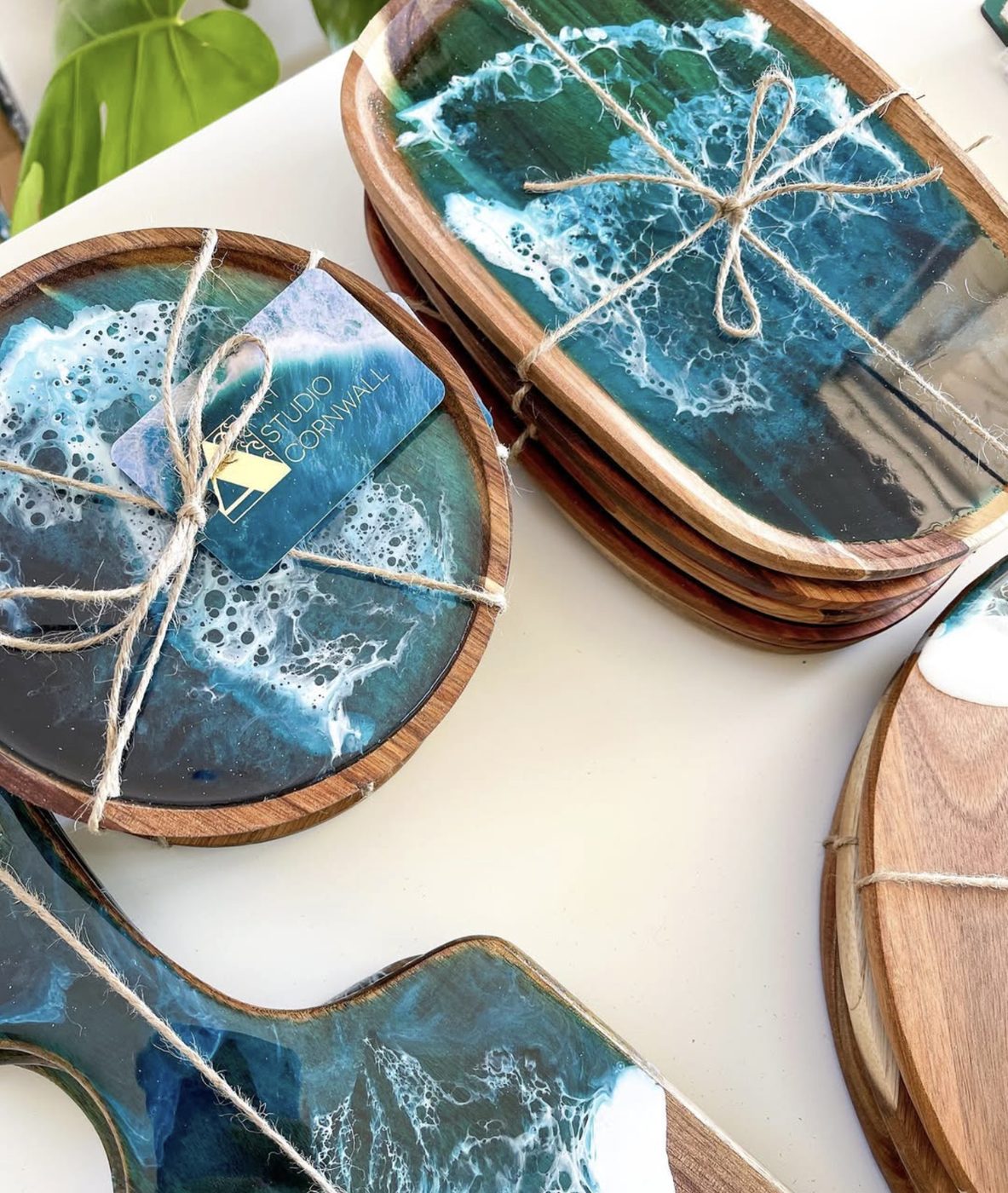 Resin ocean serving boards wrapped in twine with Art Studio Cornwall tags, ready to post.