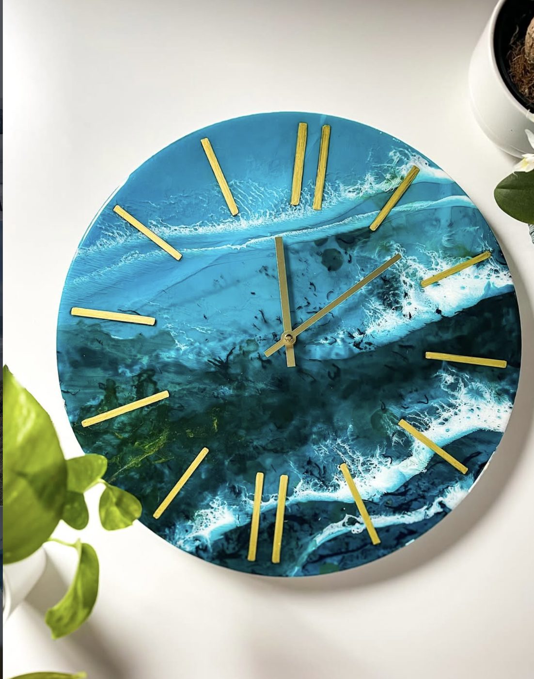 Resin ocean wall clock with gold hour markers.